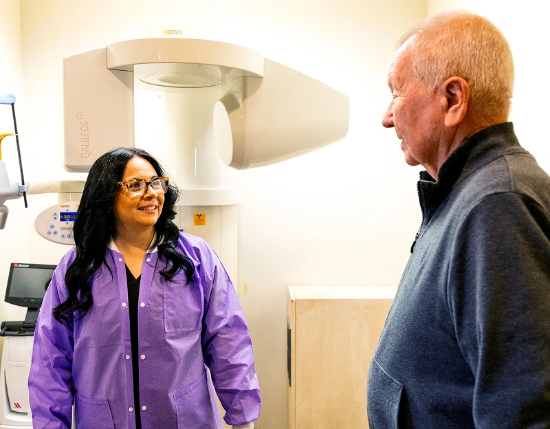 Dental team member using CBCT 3D imaging technology with a patient at Dr. Andrew Jackson DDS in Nashville, TN