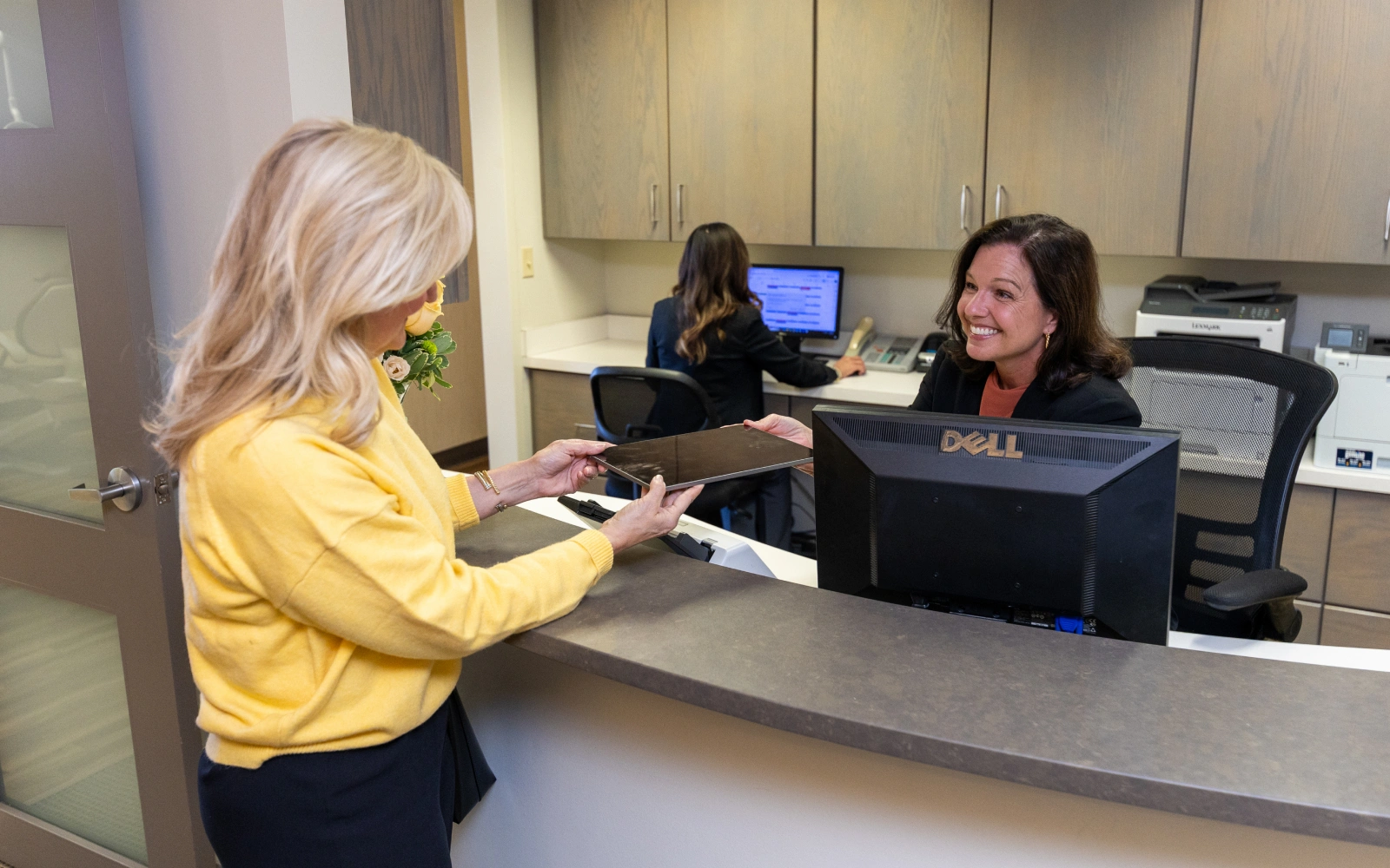 Front desk team member warmly welcoming a new patient at Dr. Andrew Jackson DDS in Nashville, TN