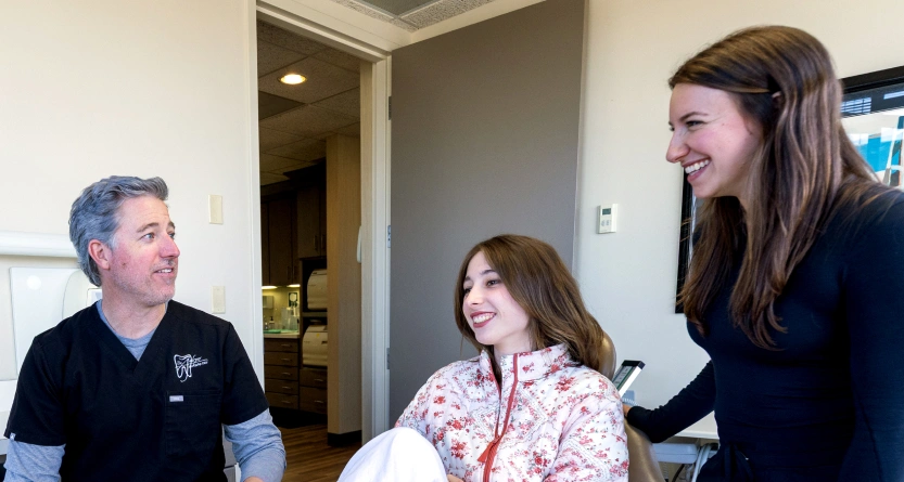 Dr. Andrew Jackson DDS warmly interacting with a patient in the dental office