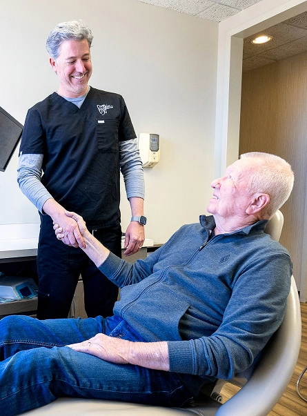 Dr. Andrew Jackson DDS consulting with a male patient about dental implant candidacy at his Nashville, TN practice